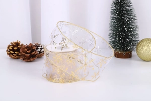 Detail of white sheer Christmas ribbon with gold snowflake patterns and metallic edges