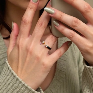 Detail of adjustable 18K gold plated ring with teardrop zircons on a model's finger