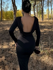Detail of elegant black long sleeve dress featuring a deep cowl back and slim fit design