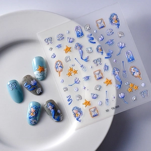 Detail view of 5D embossed mermaid and seashell nail stickers with textured patterns