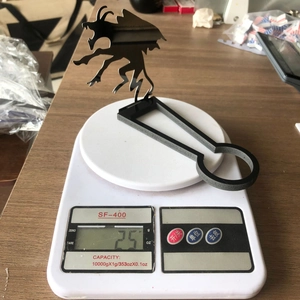 Detail shot showing the funny dragon shadow candle holder weighing 25g on a scale