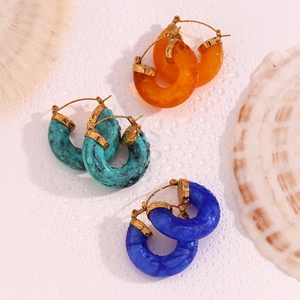 Detailed view of colorful chunky hoop earrings with gold plated textured metal clasp
