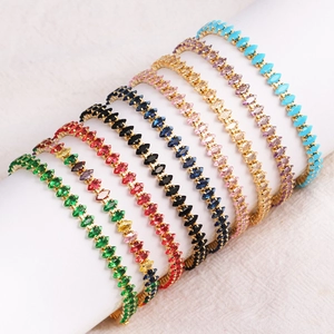 Close-up of marquise-cut colorful zircon tennis bracelets displayed on white stands