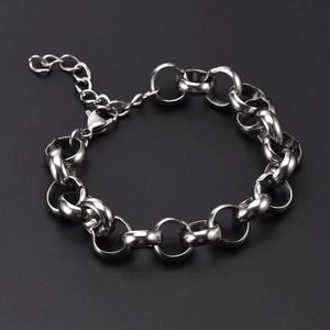 Close-up of silver steel chain link bracelet with lobster clasp on black background