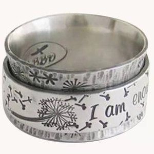Macro detail of silver ring featuring engraved dandelion and I am enough message