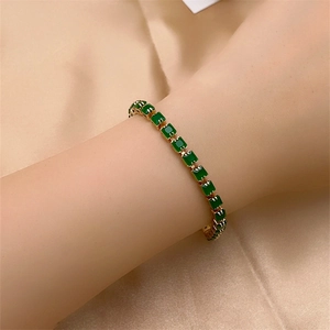 Luxurious gold-plated tennis bracelet featuring square green zircon stones on silk fabric