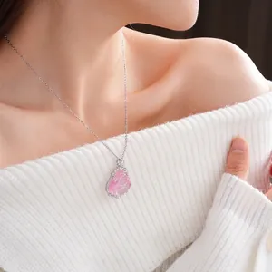 Elegant silver flower necklace with pink resin pendant and zircon on a female model