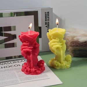Handcrafted rose flower and ghost hand scented candles in red and yellow on a magazine base