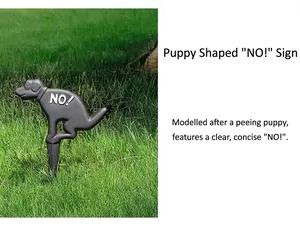 Détail d'un panneau de jardin en fonte en forme de chien avec texte NO sur herbe