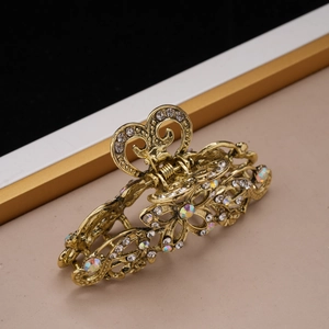 Macro view of vintage gold metal hair claw clip with colorful sparkling rhinestones