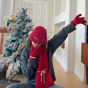 Red knitted winter set with scarf, hat and gloves featuring white drawstring details