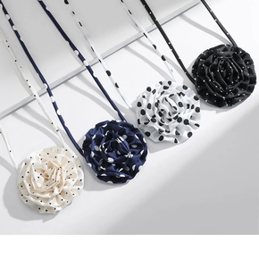 Detailed view of chiffon polka dot rose flower choker necklaces in multiple colors