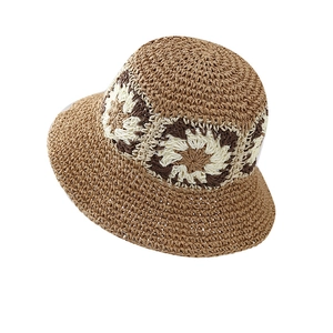 Handcrafted crochet straw bucket hat with floral pattern and wide brim for sun protection