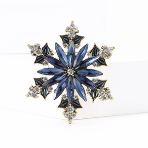 Exquisite snowflake brooch in gold and deep blue crystals for winter coats and suits