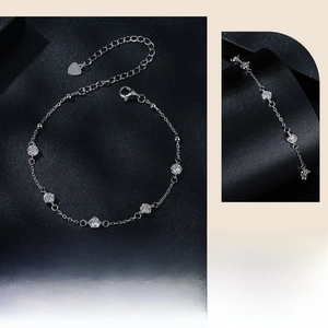 Detail of S925 sterling silver bracelet showing lobster clasp and heart charm engraving