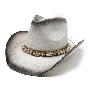 Western style beige straw cowboy hat with black gradient brim and shell decoration