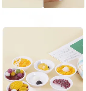 Detailed view of miniature dessert bowl models including mango pudding and taro balls