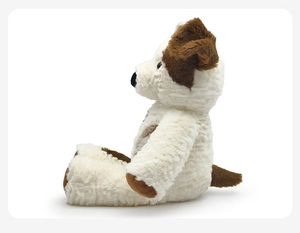 Detailed side view of a soft plush puppy toy with cream fur and brown ear patches