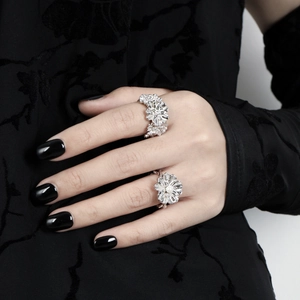 Elegant silver flower open ring with central white pearl on a model's hand