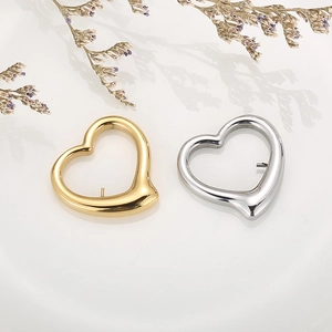 Detailed view of hollow heart-shaped pendants in gold and silver with elegant lavender deco