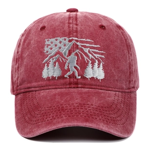 Red washed cotton baseball cap with forest and bigfoot embroidery in a vintage style