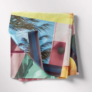 Detail of bohemian tapestry featuring colorful tropical palm patterns and pop art geometric prints