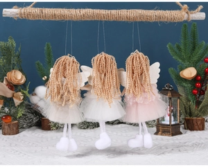 Detail of three handmade Christmas angel ornaments with lace skirts and wool hair