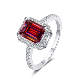 Macro view of emerald cut red moissanite ring with pave set stones in S925 sterling silver