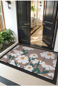 Detail of floral entrance mat with white daisy pattern and non-slip grid surface