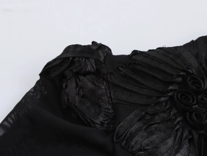 Detail of elegant black velvet evening dress with 3D floral lace embroidery on sheer mesh