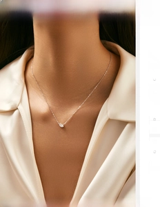 Detail of S925 sterling silver necklace with marquise cut zircon pendant on a model