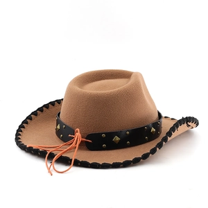 Macro detail of western fedora hat featuring leather band with bronze metal rivets and stitching