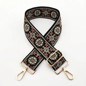 Detail of vintage floral embroidery on 5cm wide shoulder strap with gold metal buckles