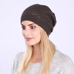 Close-up of a dark brown knit slouchy beanie with delicate openwork pattern for autumn