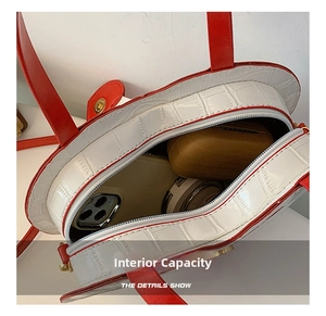 Internal view of heart-shaped crossbody bag with crocodile texture showing large capacity