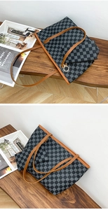 Detail of checkered tote bag and clutch set with brown leather straps on a wooden bench