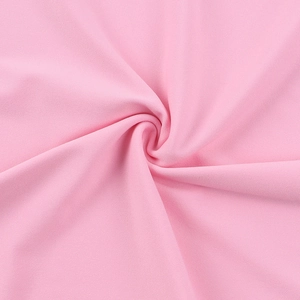 Gros plan sur la texture du tissu tricoté rose montrant le tissage fin et le drapé