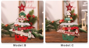 Close-up of festive wooden Christmas tree ornaments with red and green beads and greetings