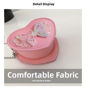 Detail of pink heart-shaped bag featuring a glittery mesh butterfly and fine stitching