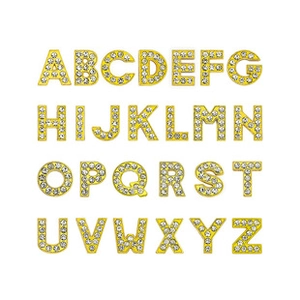 Macro shot of 26 gold alphabet pendants set with clear rhinestones for DIY jewelry