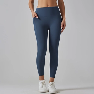 Close-up of high-waisted yoga pants with side pockets in matte navy blue fabric