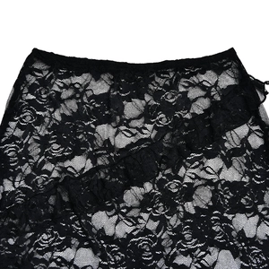Close-up of black lace skirt fabric featuring delicate floral patterns and ruffled edges