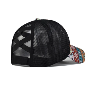 Detail of black mesh ponytail cap with criss-cross elastic bands and ethnic print brim