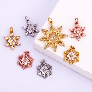 Macro shot of gold and silver snowflake pendants with embedded transparent gemstones