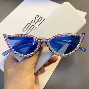 Macro shot of cat eye sunglasses featuring colorful rhinestones and blue lenses