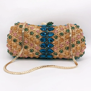 Macro detail of luxury stone clutch bag featuring floral rhinestones and blue gemstones