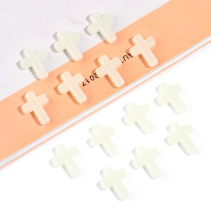 Detailed top view of luminous cross beads for DIY jewelry and necklace crafting