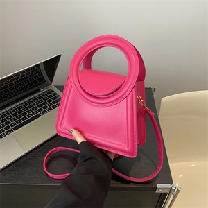 Minimalist rose pink tote bag with circular handle and crossbody strap for women