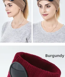 Detail of burgundy knitted headband with goggles showing texture and ear protection