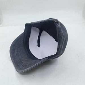 Detail view of washed grey military cap interior showing neat stitching and metal buckle
